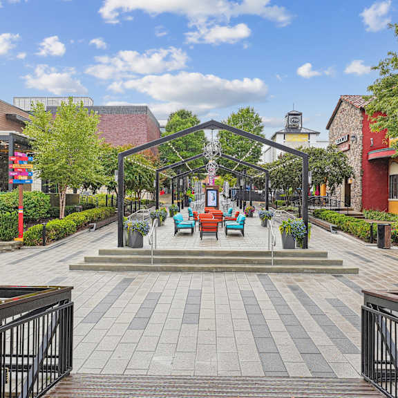 A walkway leads to a building with a sign that starts with the letter N.