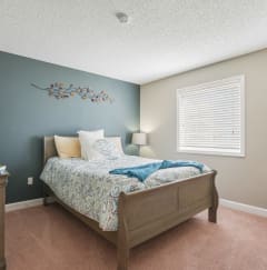 a bedroom with a bed and a dresser and a window  at Cape Landing, Myrtle Beach, South Carolina