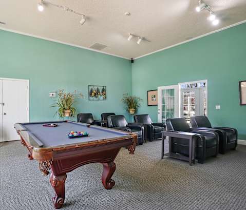 a game room with a pool table and leather furniture  at Cape Landing, Myrtle Beach, South Carolina