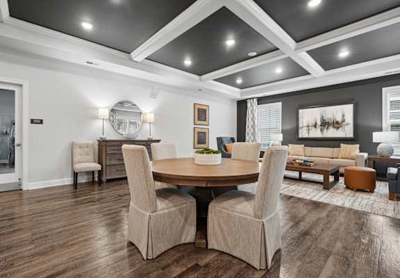 A modern dining room with a wooden table and chairs.