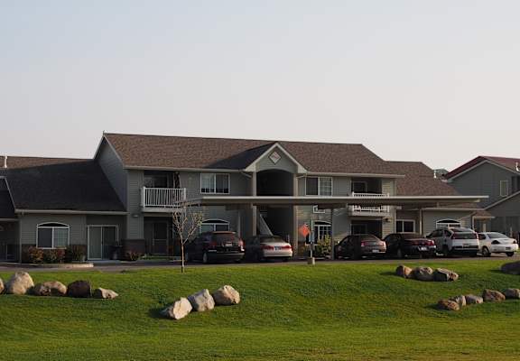 a large building with cars parked in front of it