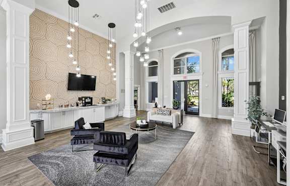 A living room with a television, sofas, and a rug.