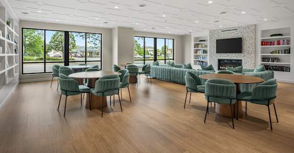 A modern living room with a large table and chairs.