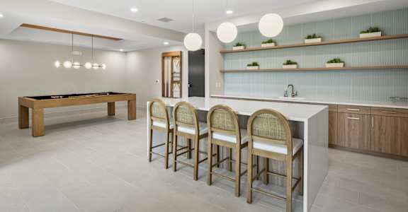 A modern kitchen with a pool table.