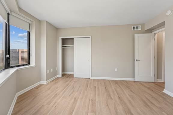 A room with a wooden floor and white walls.