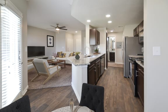 a living room with a kitchen and a dining room at The Legends at Eagle Mountain Lake, Fort Worth, 76179