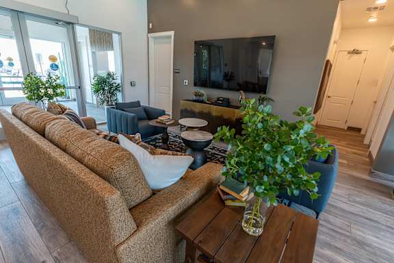 A living room with a brown couch and a wooden coffee table.