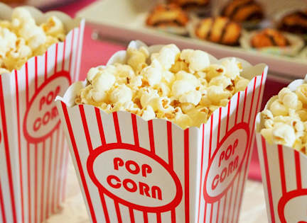 Popcorn in red and white striped boxes.