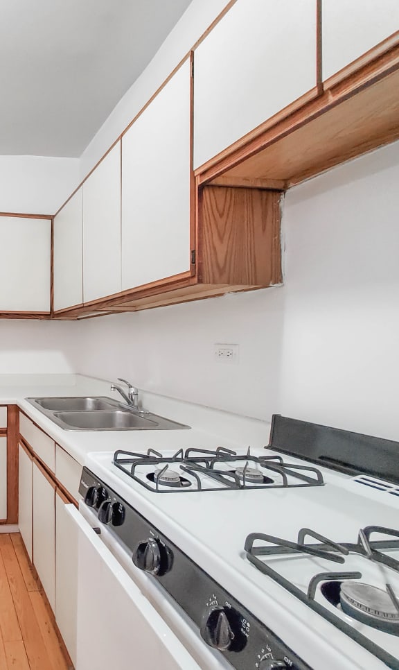 a kitchen with white cabinets and white appliances