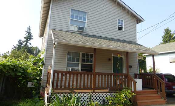 the front of the house with the deck