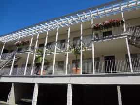 Garages below balcony enterances to apartments at Villa Knolls Apartments in La Mesa, California.
