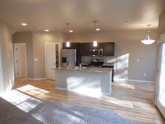 kitchen with island, dining area, unfurnished