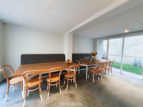 a dining room with a large wooden table and chairs