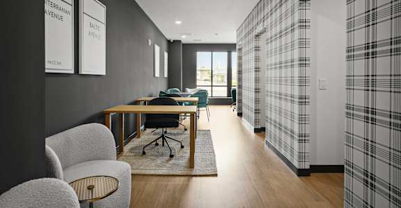 A modern office space with a long table and chairs.