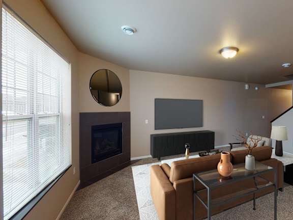 A living room with a fireplace, a couch, a coffee table, and a television.
