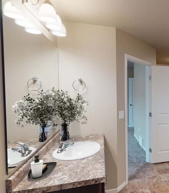 A bathroom with two sinks and a mirror.