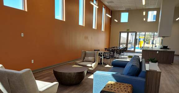 a lounge area with couches chairs and tables