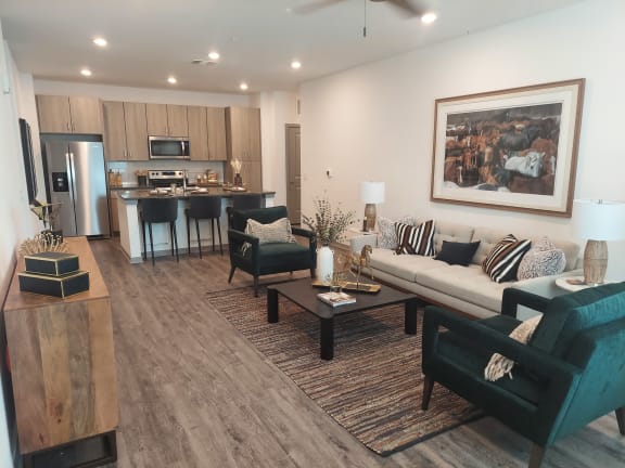 a living room with a couch coffee table and chairs and a kitchen with a refrigerator and microwave at Canter, Ocala, FL, Florida, 34474