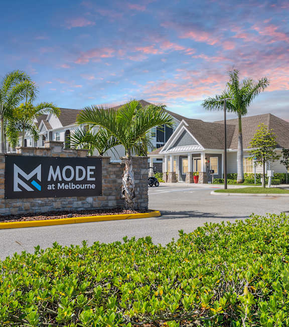 A pool with a water slide and a building in the background at Mode at Melbourne, LLC Apartments, Melbourne, 32901