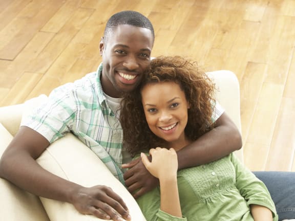 a man and woman sitting on a couch