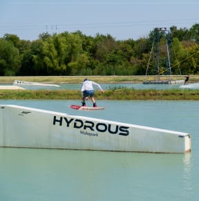 a skateboarder doing a trick on a ramp in the water