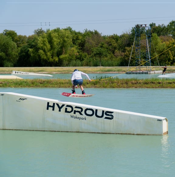 a skateboarder doing a trick on a ramp in the water
