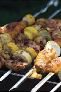 a close up of some skewers of food on a grill