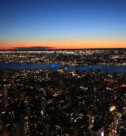 a view of the city at night from the top of the empire state building