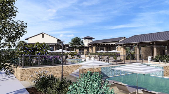 a swimming pool with lounge chairs and umbrellas in front of a building