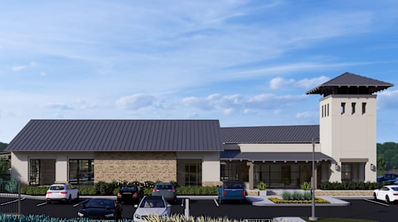 a rendering of a building with cars in a parking lot