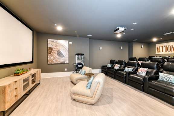 A home theater with a large screen and comfortable seating.