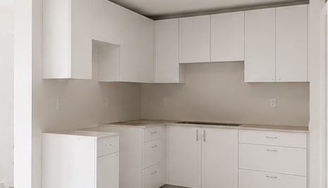 A kitchen with white cabinets and stainless steel appliances.