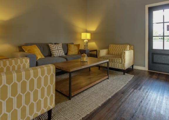 a living room with couches and chairs and a table