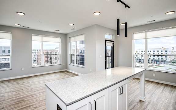 A spacious kitchen with a large island and a view of the city.