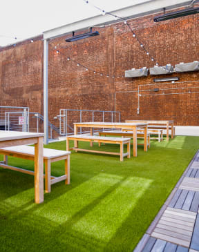 a row of benches in front of a brick wall at East 4th Street, Cleveland, 44115