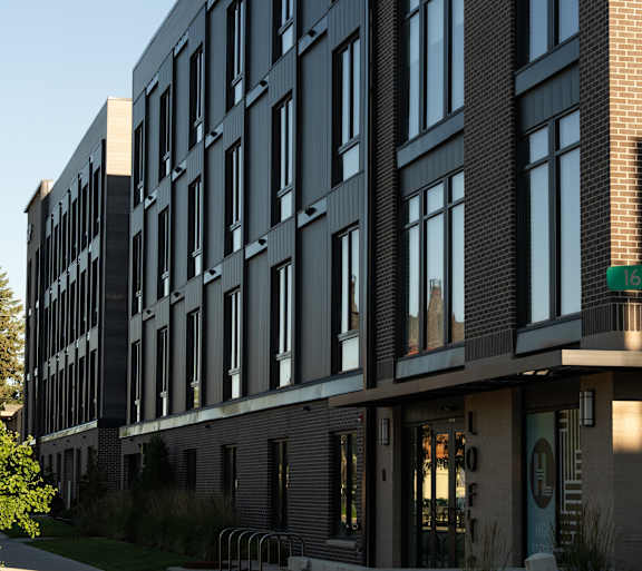 a large building with a sidewalk in front of it