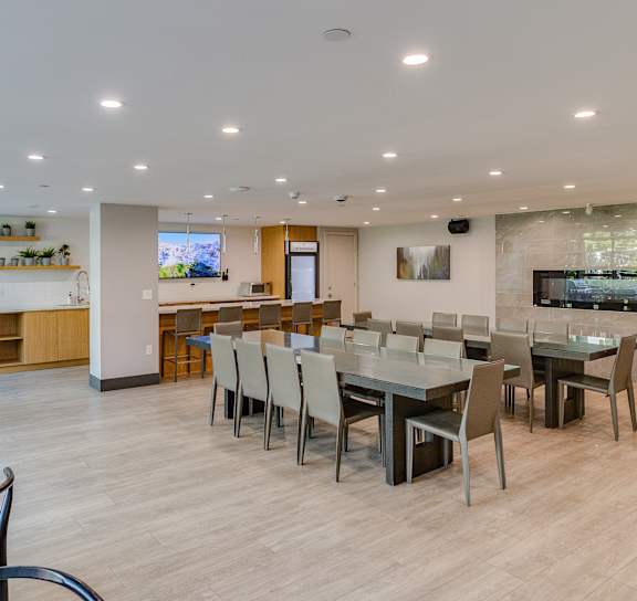 a dining room with a table and chairs and a kitchen