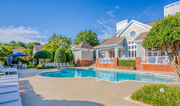 A house with a pool in front of it.