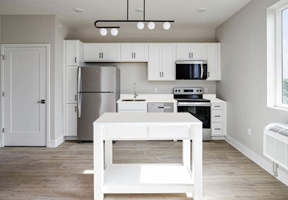 A kitchen with a white table and stove top oven.