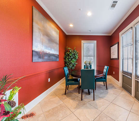 A dining room with a table and chairs.