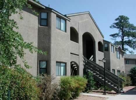A building with a grey facade and a black staircase.
