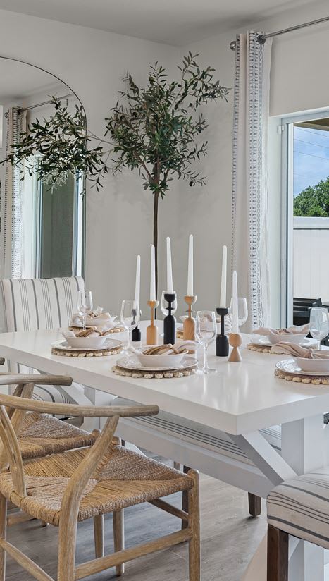 a dining room with a white table and white chairs