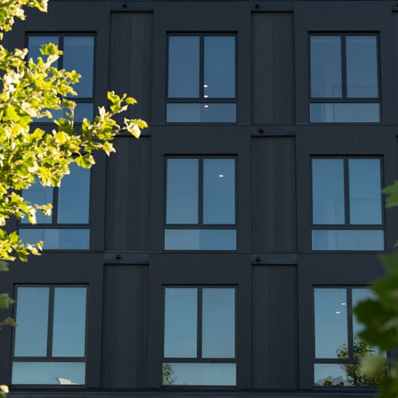a new apartment building on the corner of a sidewalk