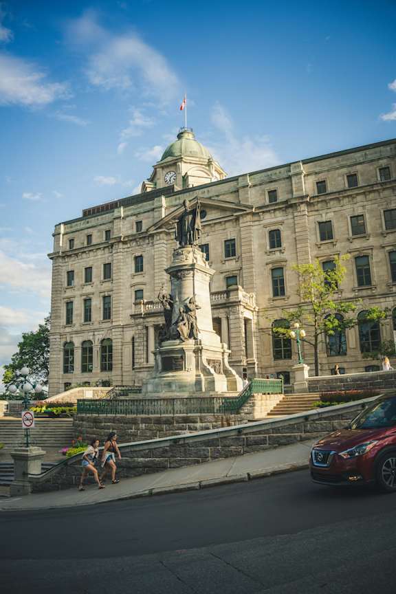a large building with a statue in front of it