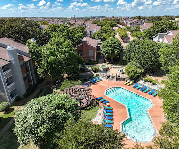 an aerial view of a resort style swimming pool with lounge chairs