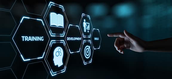 a person pointing to a digital screen with the word training and an icon of a