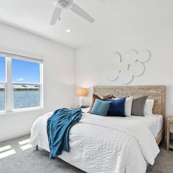 A bedroom with a bed, a window and a wooden chest. at Marisol, Bradenton, FL