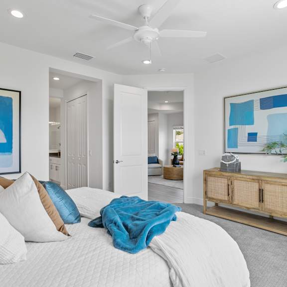 A white bed with a blue wall and curtains. at Marisol, Bradenton, 34211