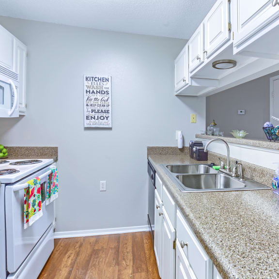 a kitchen with granite counter tops and white appliances