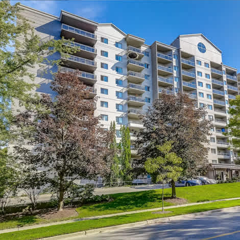 a large apartment building with trees in front of it